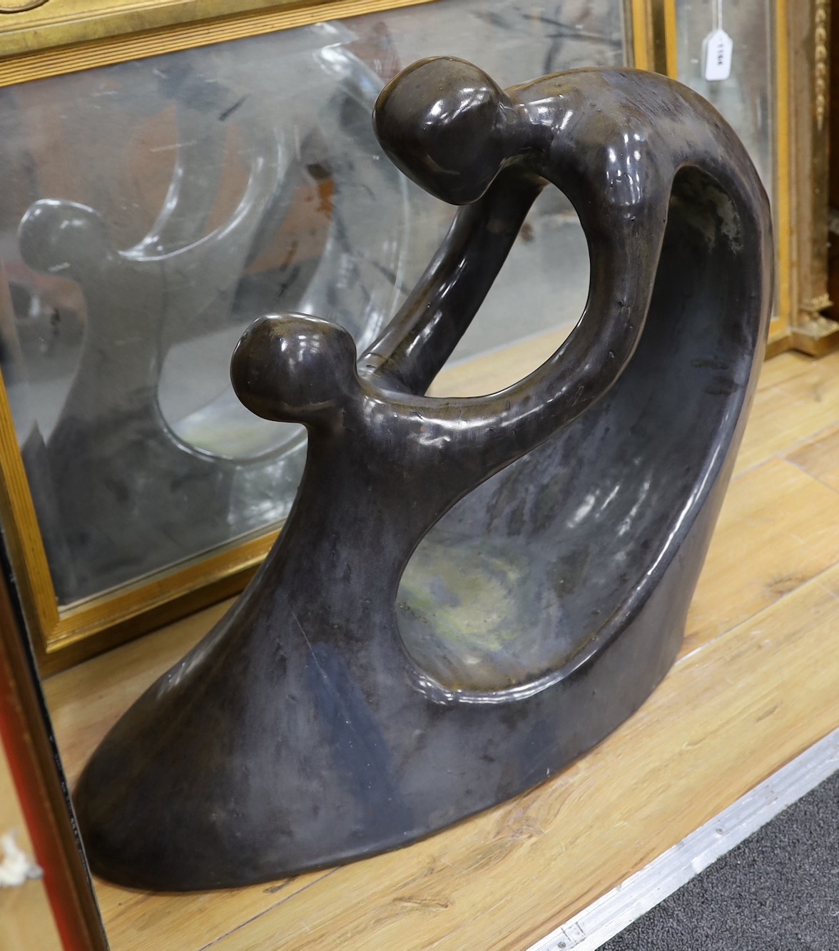 A silver lustred terracotta sculpture in the style of B. Hepworth, 59cms high